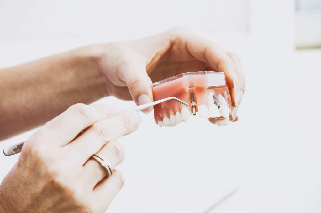cosmetic and family dentist holding dentures